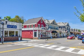 A street view with a Bluefin's restaurant, a red building, and a crosswalk.
