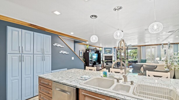 A modern kitchen with granite countertops, a double sink, and wooden cabinets. - Beautiful Mainsail Townhome Sleeps 8 .   3 bedrooms3 bathrooms Gated Community  (Miramar Beach)