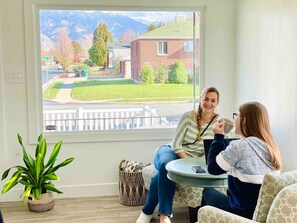 Enjoy a peaceful view of the surrounding neighborhood from the large window in this cozy room.