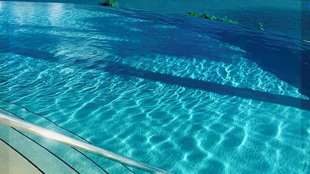 A clear view of an infinity pool with a wooden deck and a view of the ocean and sky. - THE BEST OCEAN VIEW GUARANTEED!!! (Fajardo)