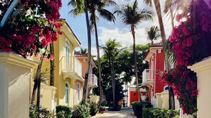 A narrow, sunlit pathway flanked by buildings with balconies, leading towards a central point. - THE BEST OCEAN VIEW GUARANTEED!!! (Fajardo)
