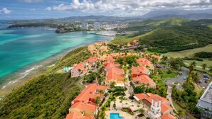 A coastal resort with red-roofed buildings, a swimming pool, and lush greenery. - THE BEST OCEAN VIEW GUARANTEED!!! (Fajardo)