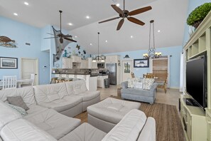 Relax in this stylish living space with a comfortable sofa, armchair, and flat-screen TV.