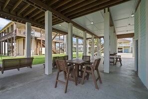 Enjoy dining or socializing in this outdoor patio area with benches and tables.