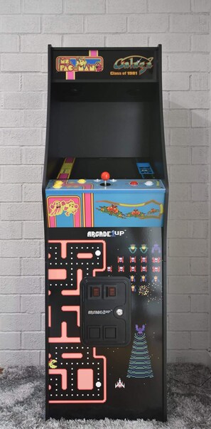 A retro arcade machine with a black cabinet and colorful graphics, including characters from 'Pac-Man' and 'Galaga'. - Wine Country Backyard Escape (Santa Rosa)