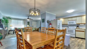 A modern kitchen with white cabinets, a built-in oven, microwave, and refrigerator. - Beautiful 4 bedroom 2 full bathroom close to everything! (Champaign)