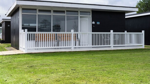 A modern single-story building with a white exterior and large windows. - 57 Cherry Park (Skegness)