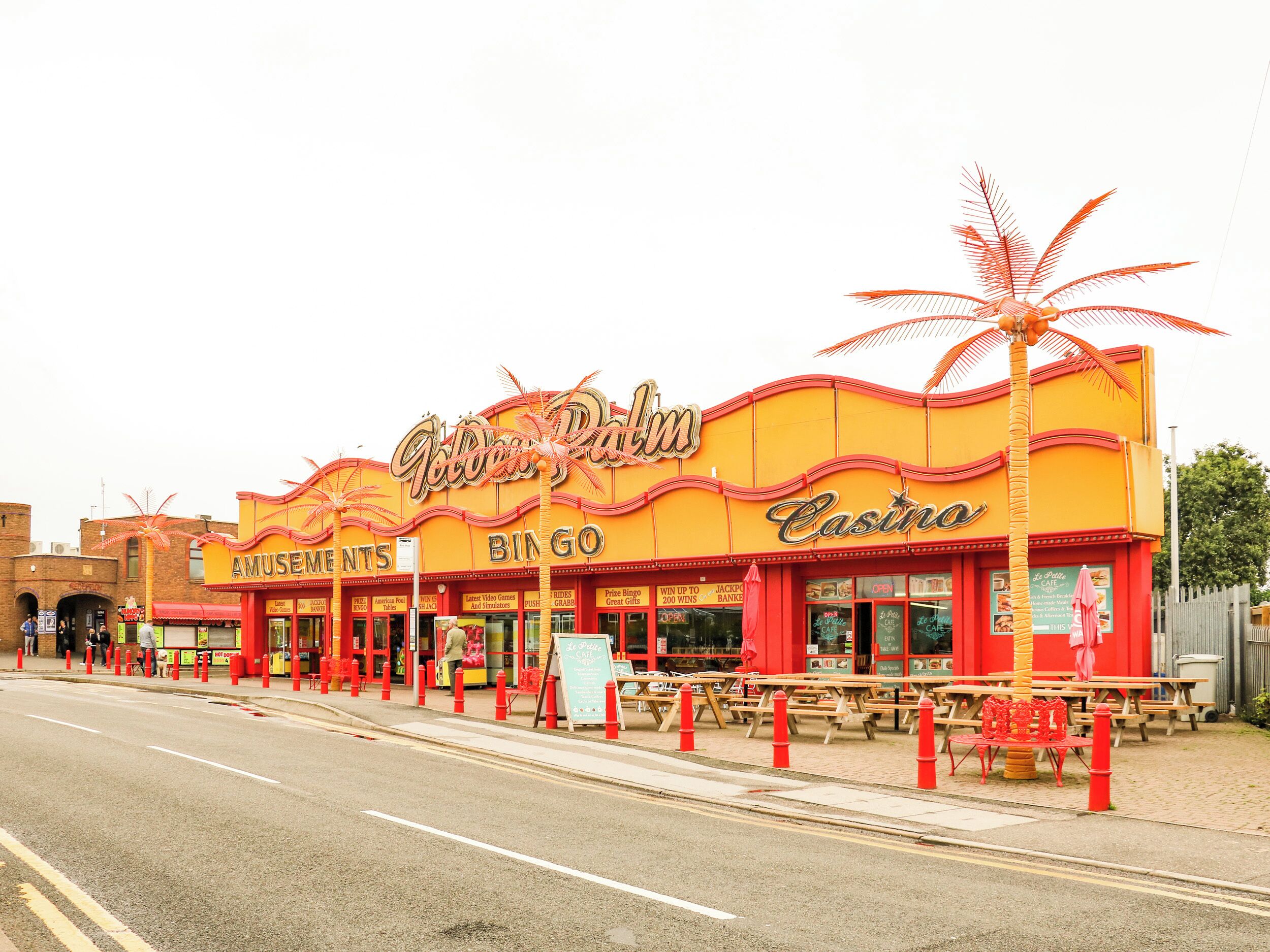 A building with a sign that reads 'Golden Palm Casino' and 'Amusements Bingo.'
