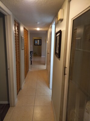 Enter a functional hallway with a door leading to a room.