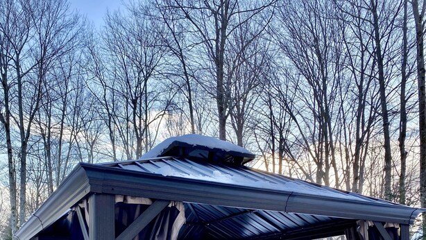 A hot tub with a wooden structure and curtains, surrounded by snow and trees. - 5-BR House/Backyard/2 Lakes/4 Beaches/3Pools/Playgrounds (Pocono Lake)