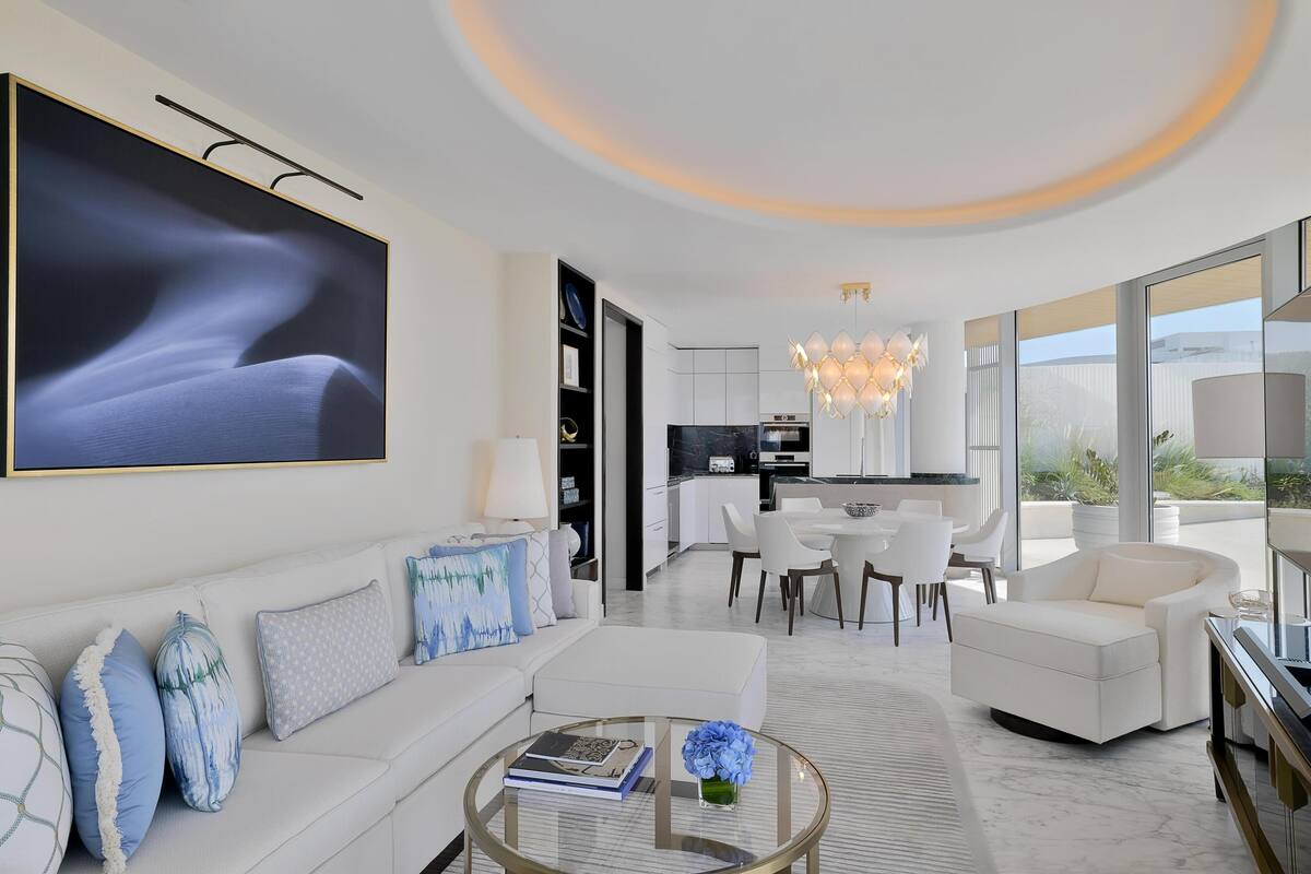 A modern living room with a sofa, coffee table, and artwork.