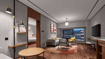 Deluxe Suite, 1 King Bed | Living area | 34-inch LCD TV with digital channels