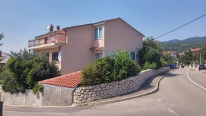 A two-story building with a stone wall and a red-tiled roof. - Sea view apartment, 7 minuts from beach (Novi Vinodolski)