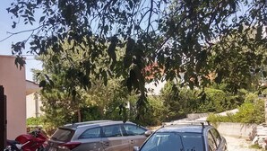A parking area with two cars and a motorcycle. - Sea view apartment, 7 minuts from beach (Novi Vinodolski)