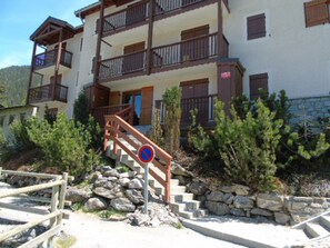 A multi-story building with balconies, a staircase, and a no parking sign. - Charming apartment - 6 guests Valley view (Valfréjus)