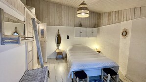 A bedroom with a bed, bedside tables, a mirror, a hanging light fixture, and a wooden ceiling. - Ty Laouen, Peaceful fisherman's cottage, close to the beach, WIFI (Quiberon)
