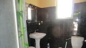 A bathroom with a white sink, a toilet, and a mirror above the sink. - 1 Bedroom Apartment in Carnoux-en-Provence (Carnoux-en-Provence)