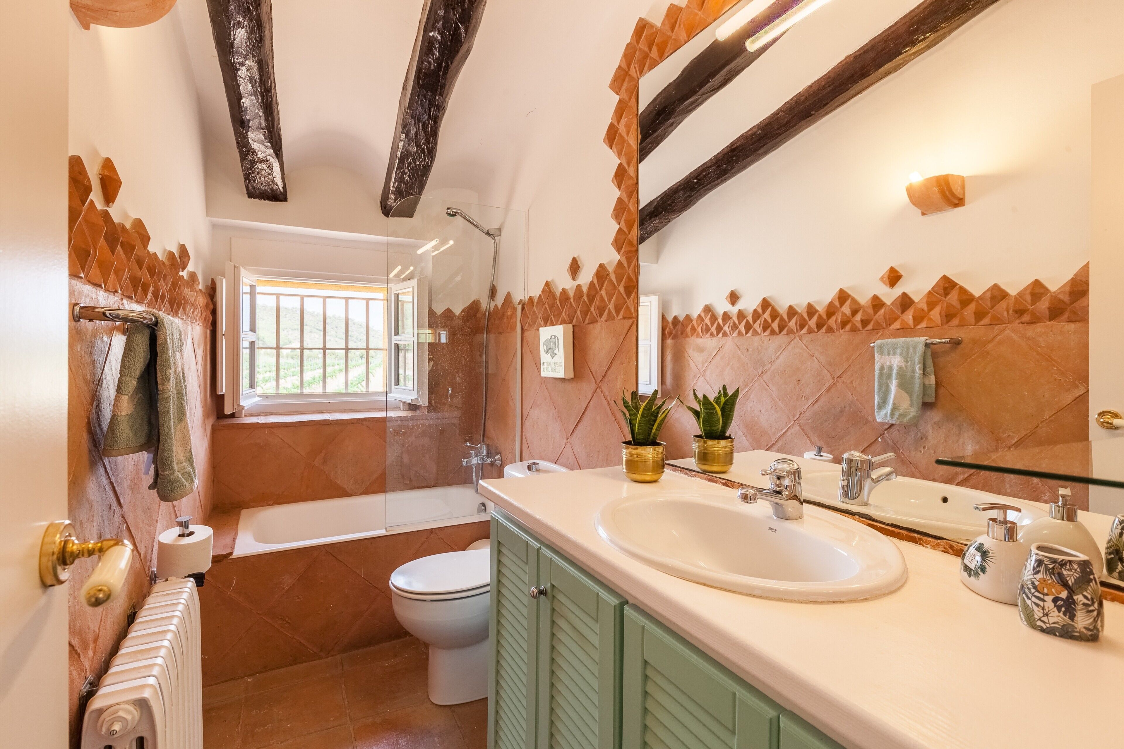 A bathroom with a bathtub, toilet, and sink.