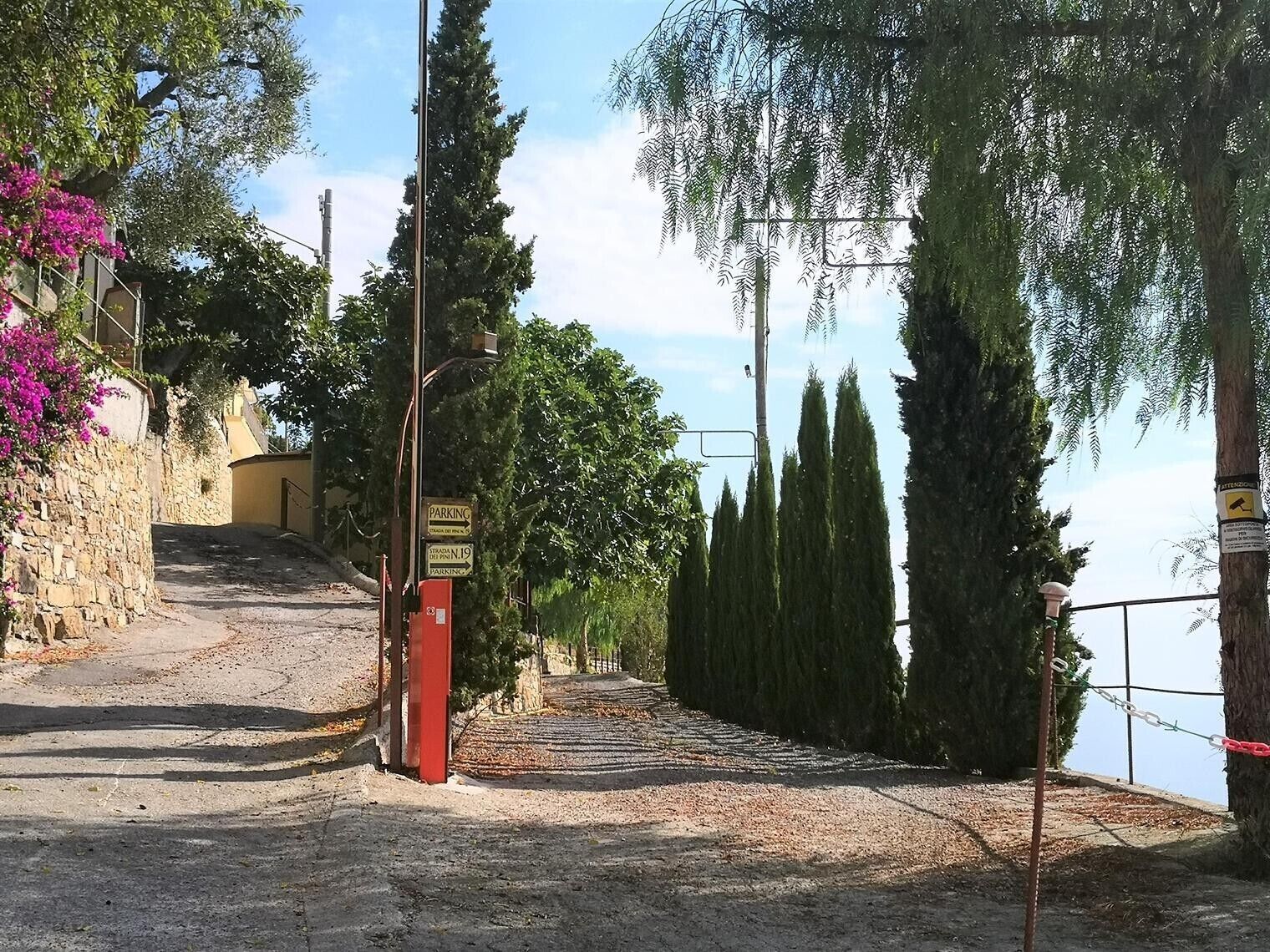 A gated entrance with a sign indicating parking restrictions.