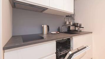 Fridge, stovetop, dishwasher, coffee/tea maker