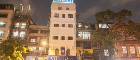A hotel with a prominent sign reading "CITY HOTEL" at the top.