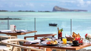A dining table with breakfast items and a view of the ocean. - Sea Diamond Boutique Hotel & Spa by Sea Resorts (Calodyne)