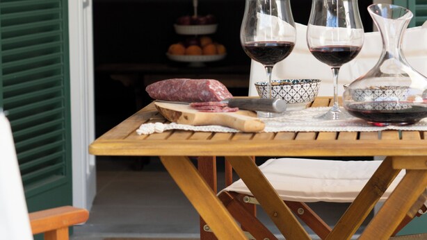 A dining table with a bottle, glasses, and a bowl. - Il Poggio, an exclusive location with parking (Firenze)