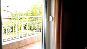 A view through a window with a metal railing outside.