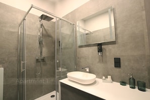Appartement Confort, patio | Salle de bain | Douche, sèche-cheveux, serviettes fournies, savon