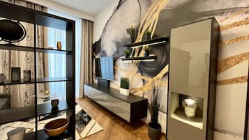 Deluxe Apartment | Living area | 32-inch flat-screen TV with cable channels, TV