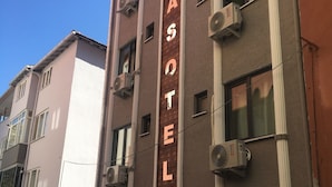 A multi-story building with a prominent sign reading "BASOTEL". - Esas Pansiyon (Gemlik)