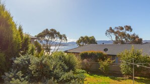 A residential property with a view of a lake and mountains in the background.
