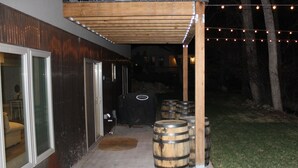 An outdoor area with a wooden pergola, barrels, and a grill. - Romantic Private Space for Couple's Getaway w/Hot Tub (Buena Vista)