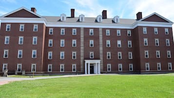 A large brick building with a symmetrical facade, multiple windows, and a central entrance labeled "Baker Hall".