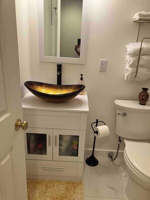 Tina con regadera, secadora de cabello, toallas, jabón