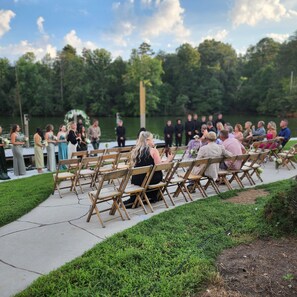 Guests can enjoy live events with a scenic view of the water and surrounding trees.