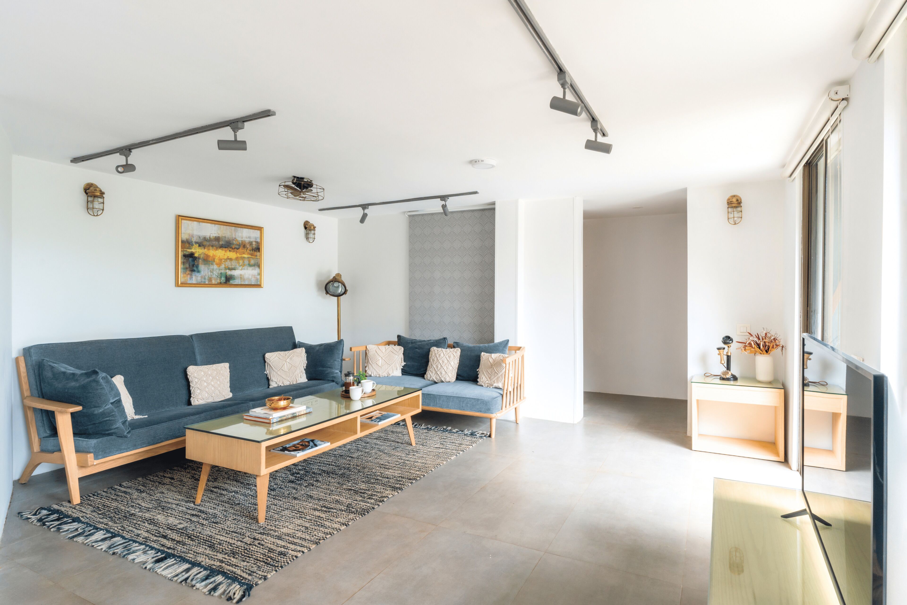A modern living room with a sofa, coffee table, and side table.