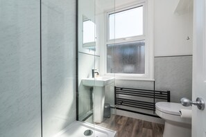 Shower, rainfall showerhead, hair dryer, towels