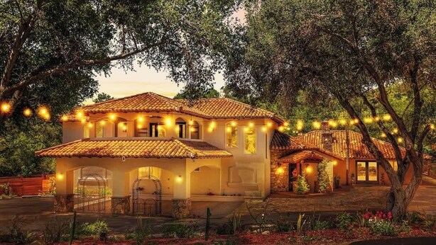 A two-story house with a tiled roof, surrounded by trees and a garden. - Spacious Luxury Retreat Sleeps 20 with Jacuzzi (Fallbrook)