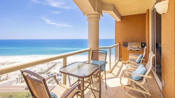 A balcony with a view of the beach and ocean, furnished with chairs and a table. - 2B Gulf Front*Tower 5*Stunning Views (Pensacola Beach)
