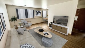 Una sala de estar moderna con un sofá, una mesa de centro, un reposapiés y un televisor.