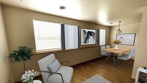 Una sala de estar moderna con un sofá, una mesa de comedor y una mesita auxiliar con una planta.