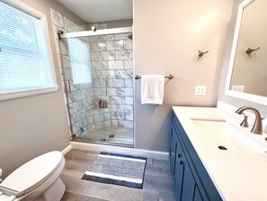 Bathtub, hair dryer, towels, shampoo