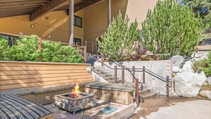 A modern outdoor seating area with a fire feature, a staircase, and a rock garden. - Seasons Four by Snowmass Vacations (Snowmass Village)