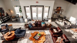 A spacious lobby with leather sofas, a central coffee table, and a large rug. - Beautiful 2BD + 2BA Home! King Beds! Hot Tub! Pool! Walk to downtown. (Whitefish)