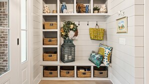 A storage area with shelves, baskets, and decorative items. - Majestic Oaks, Breathtaking Sunrise Ocean Views, Shared Pool, Near the Village (St Simons Island)