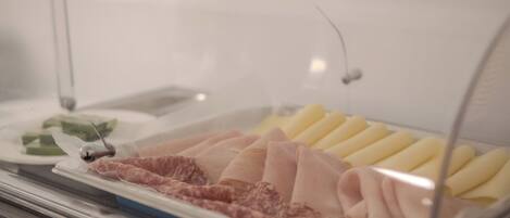 A food display case with various meats and cheeses.
