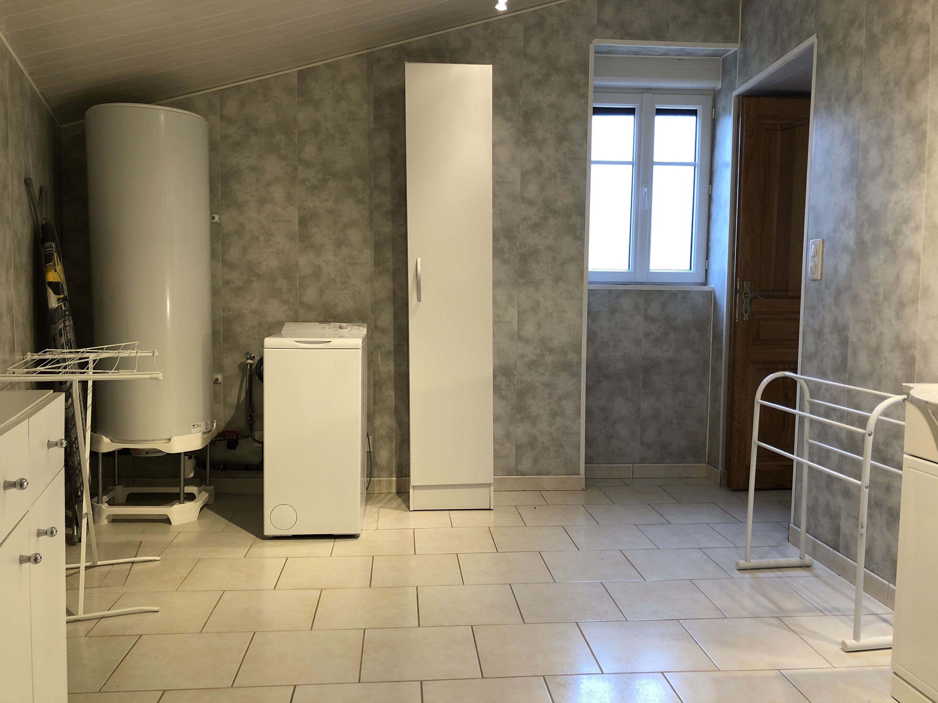 A laundry room with a washing machine, dryer, and a water heater.