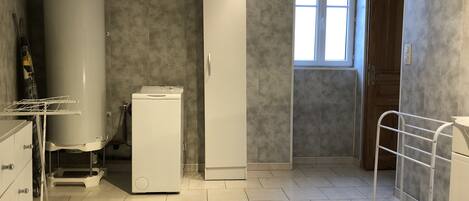 A laundry room with a washing machine, dryer, and a water heater.