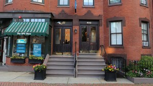 A brick building with a green awning labeled "The UPS Store" and a door marked "402". - Maverick Suites at 402 Columbus Ave (Boston)